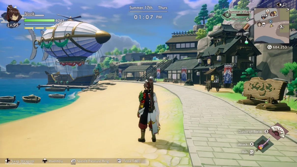 a beach with rowboats and a dirigible