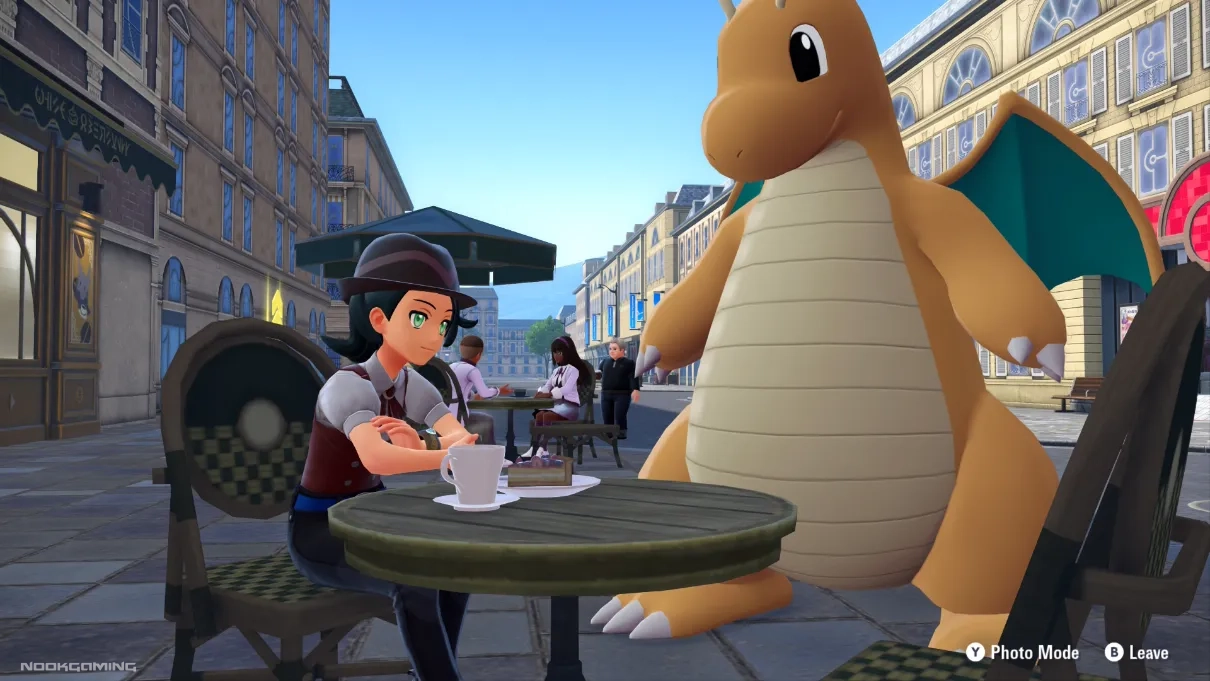 Sitting at a table in Lumiose City with a Dragonite